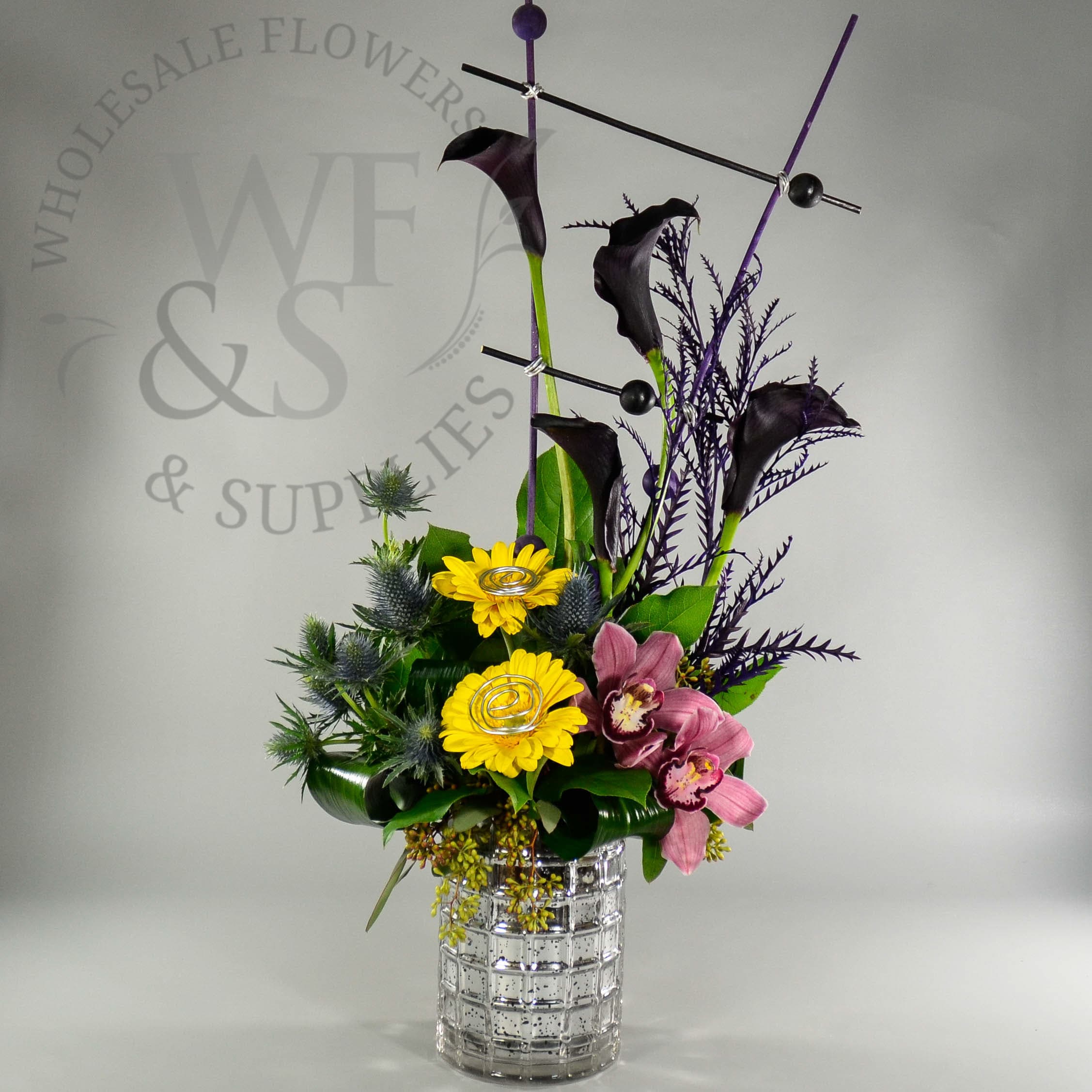Silver Ceramic Container with Daisies, Dark Knight Calla Lilies, and Orchids.