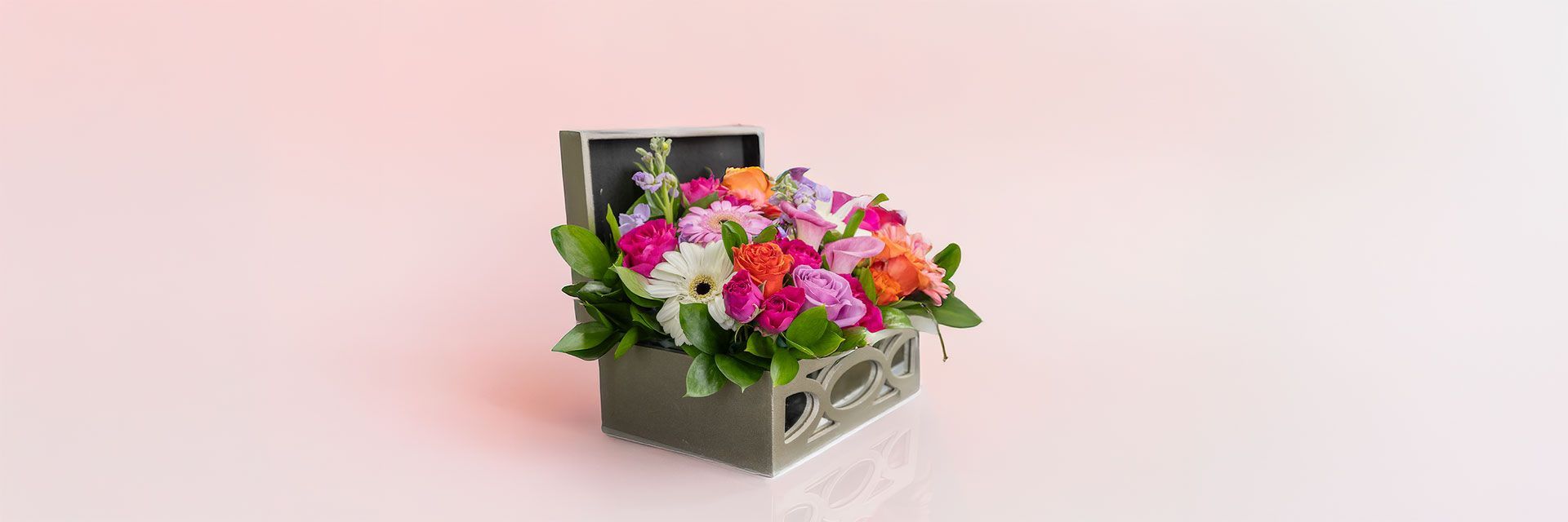 A floral arrangement in a small gray box