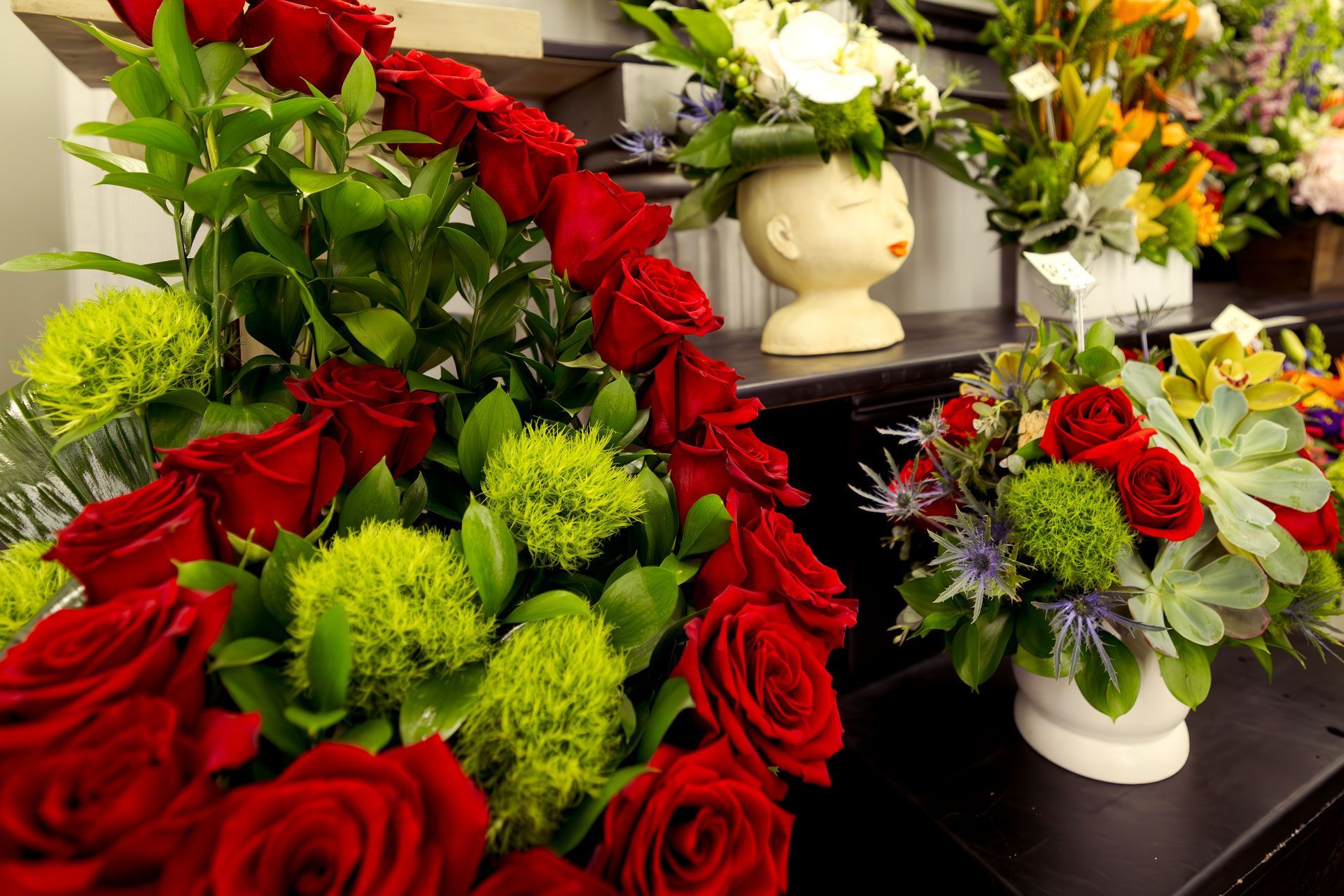 Arrangement of red roses and green flowers