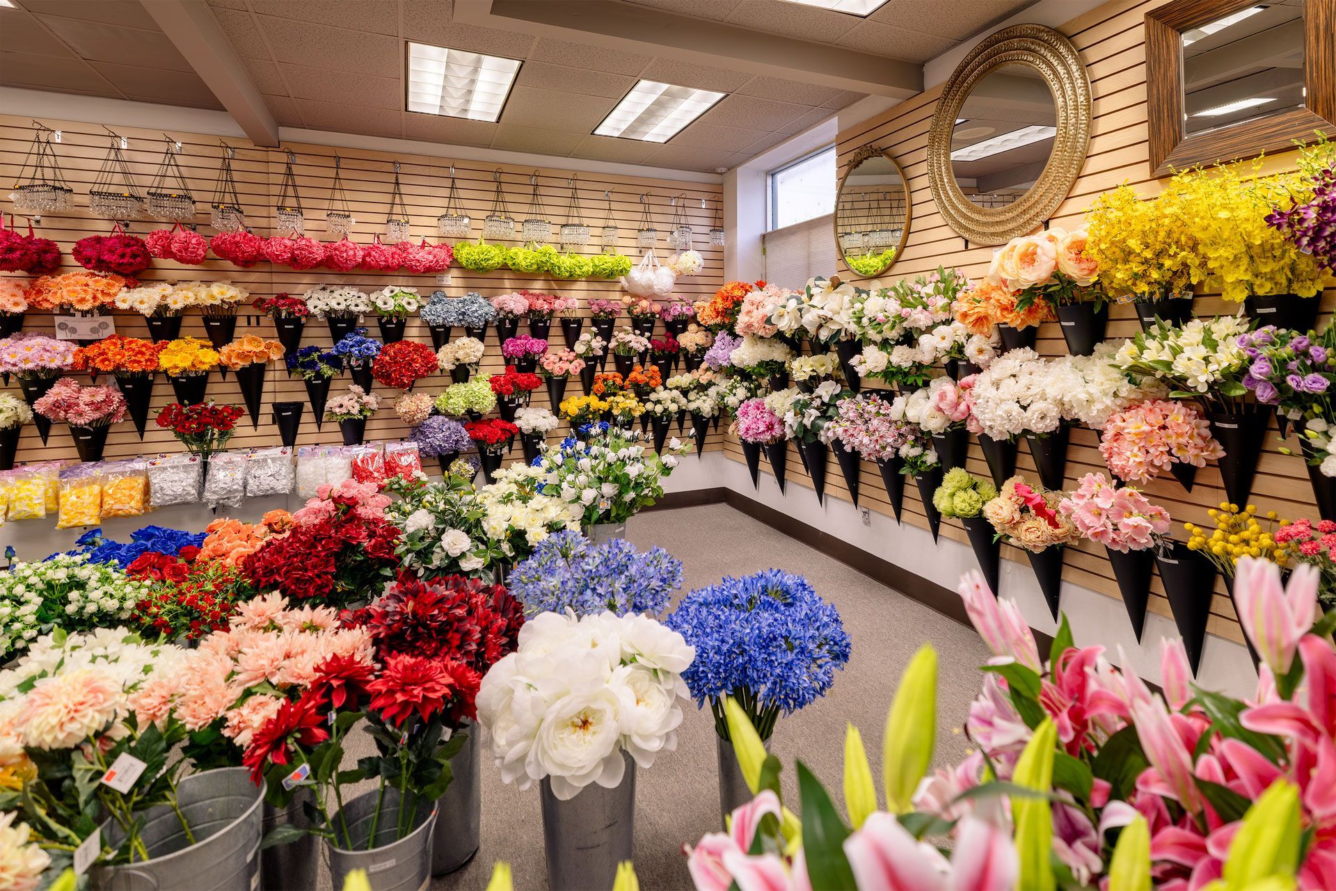 A flower shop interior displays numerous colorful bouquets